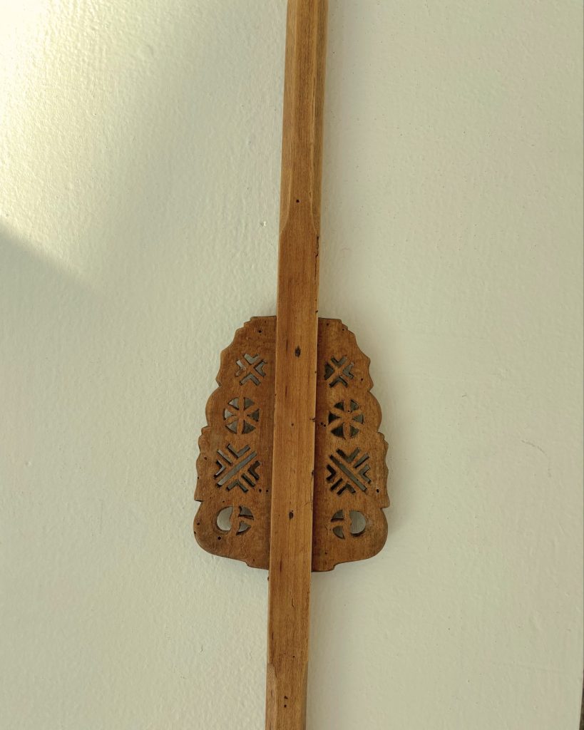 Spinning distaff with rosettes and cruciform motifs on two side wings