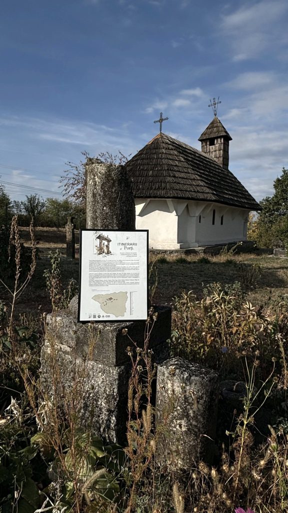 Exhibition panel in front of a wooden church at the Curtișoara museum