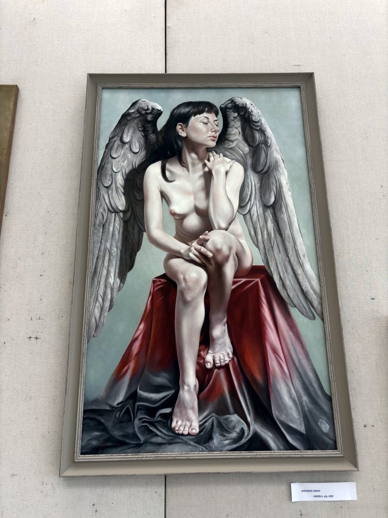 Painting of a winged nude figure on red drapery