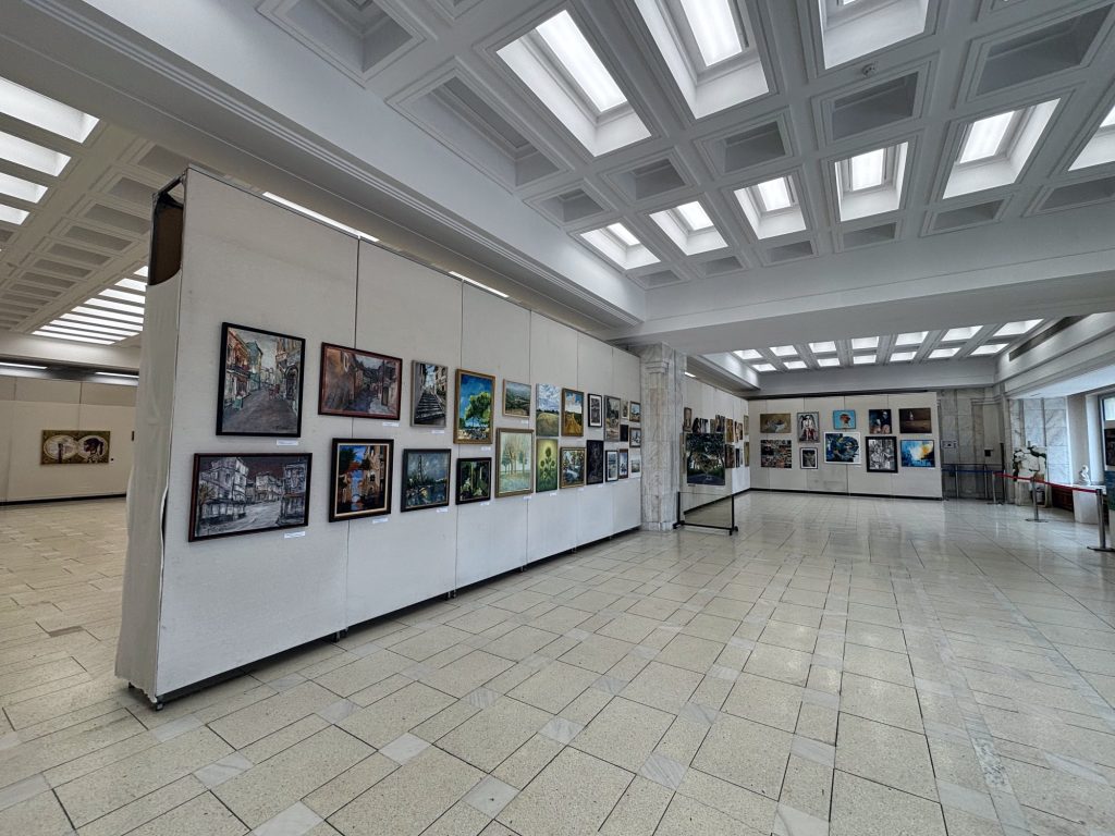 Long exhibition hall with paintings